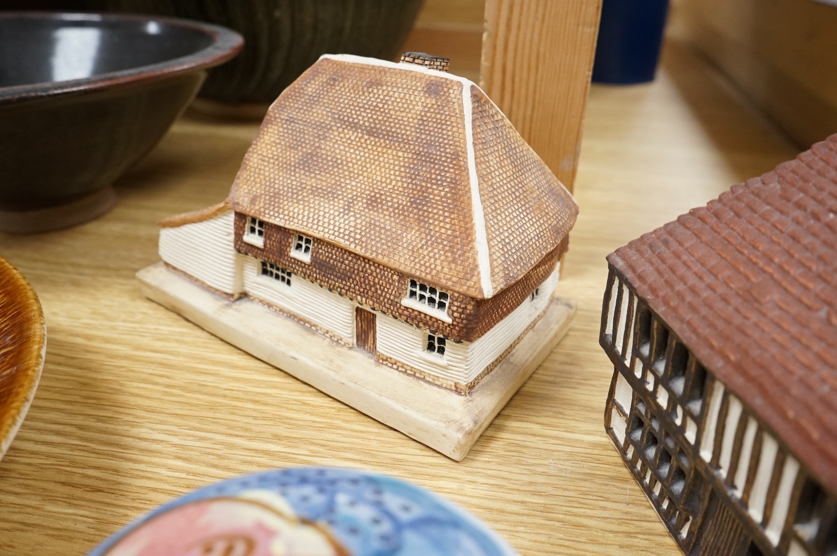 A Poole pottery Aegean dish, together with a selection of Studio pottery bowls, dishes, jugs etc and a Donoghue / Rye cottage model, Poole dish 20cm diameter (14)